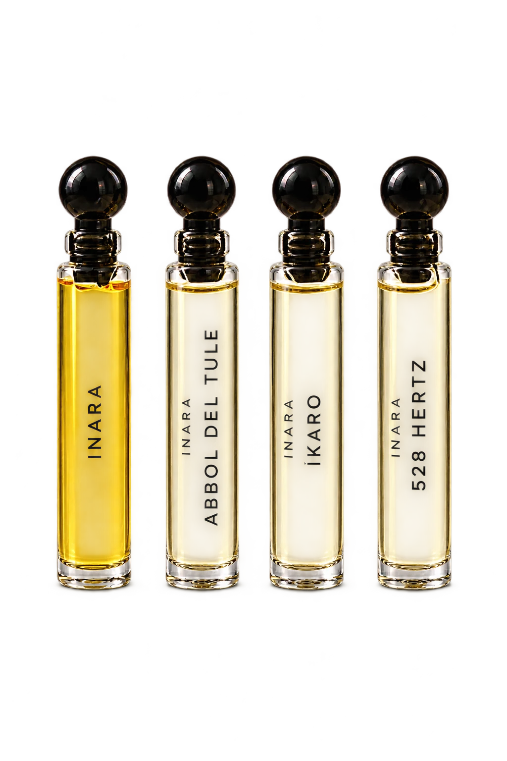 Four clear fragrance oil vials with black rounded stoppers.